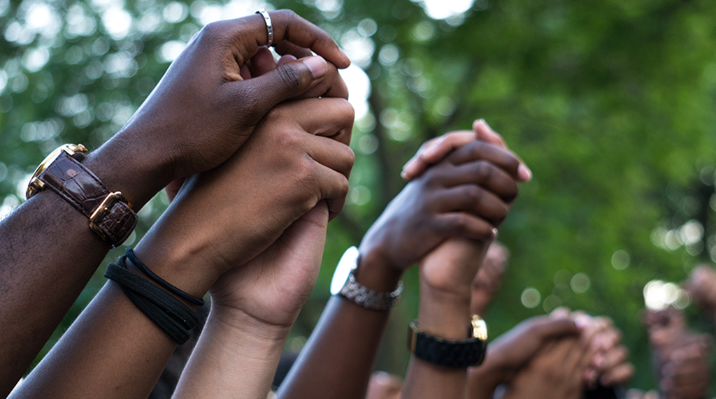 image of hands raised together