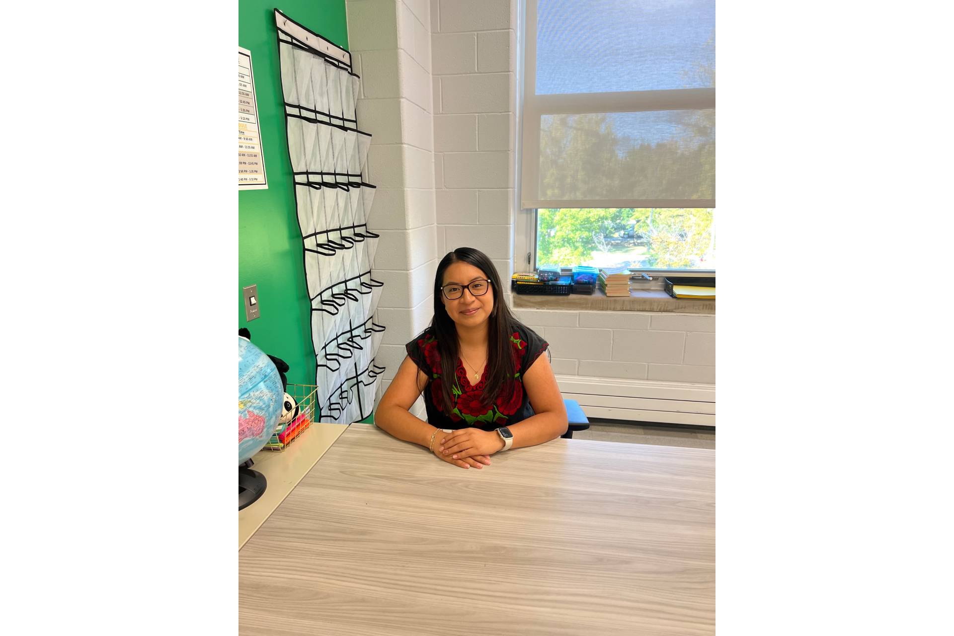 Nancy Lazaro, a math teacher and interventionist at Westinghouse College Prep, smiling in her classroom.