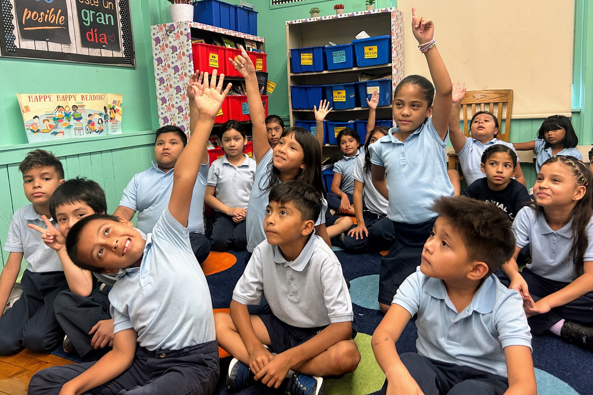 students raising hands