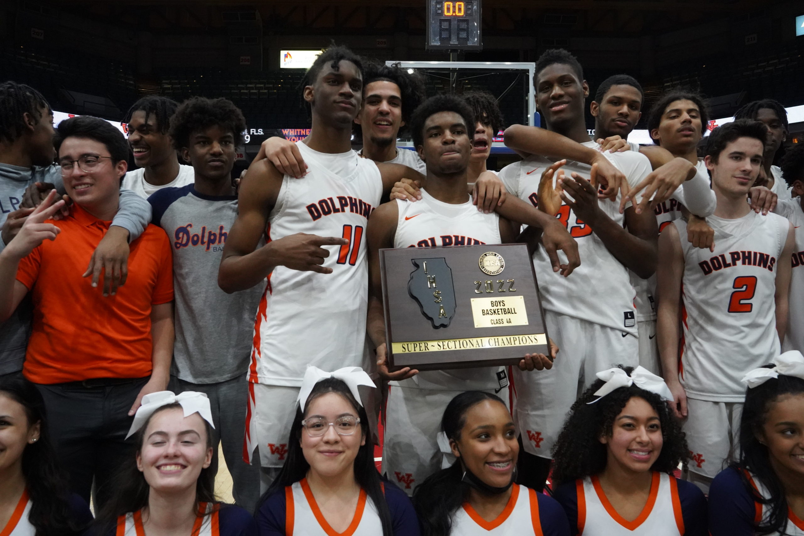 Dolphins team members holding a championship plaque