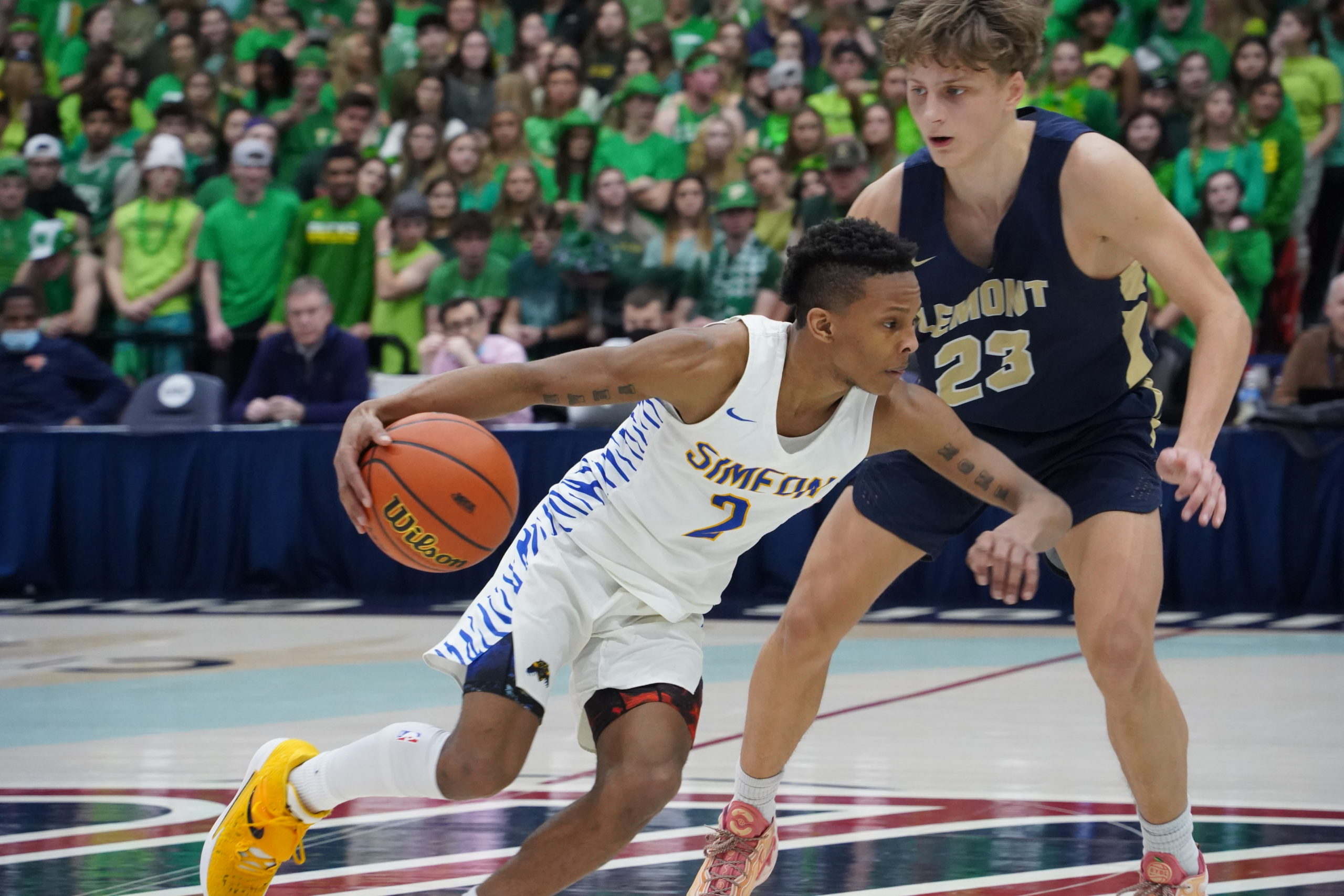 A Lemont basketball player guarding a Wolverine player