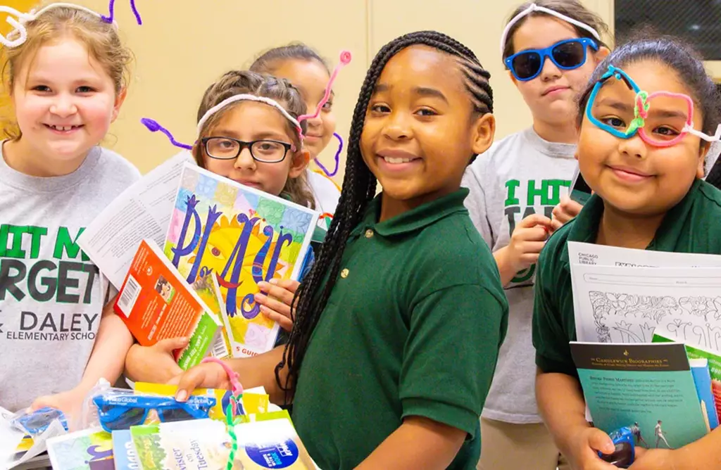 image of smiling students holding library books