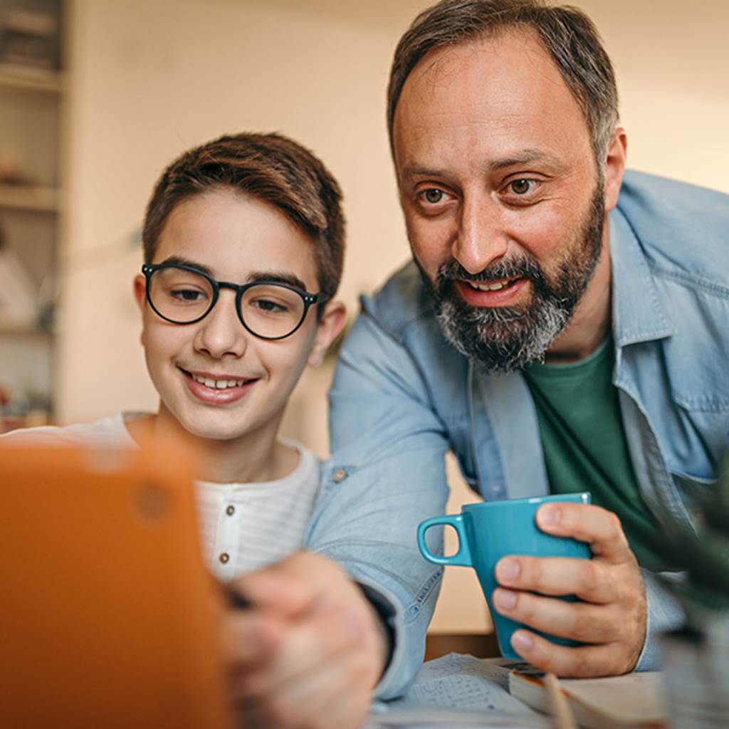 Father and son looking at an ipad