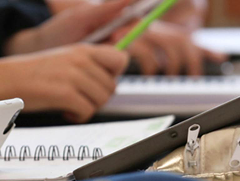 Notebooks, hands and pencils