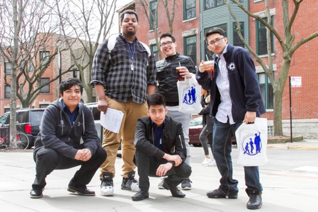 Four young males and a teacher pose