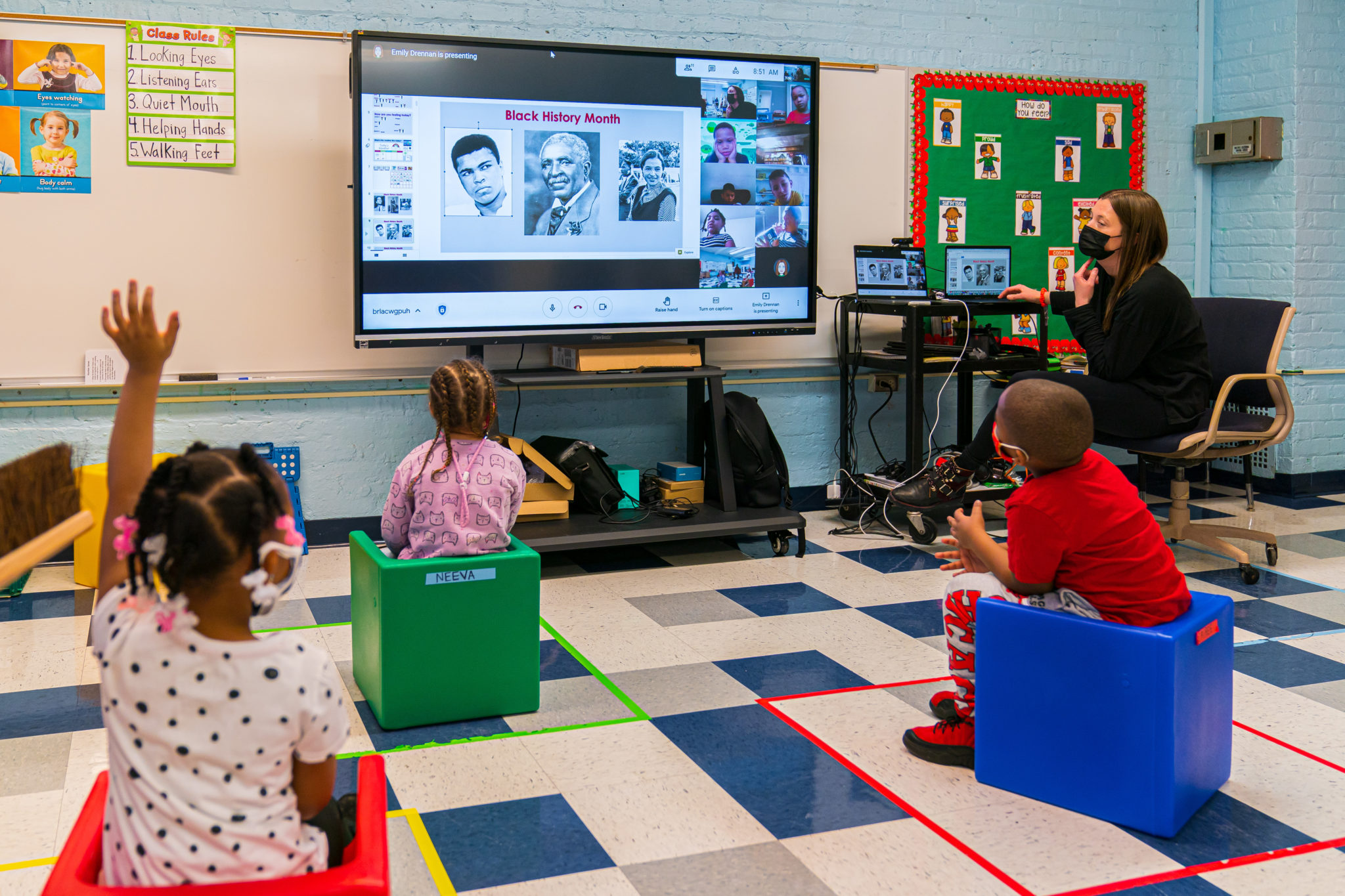 A teacher teaching Black History on a smart board