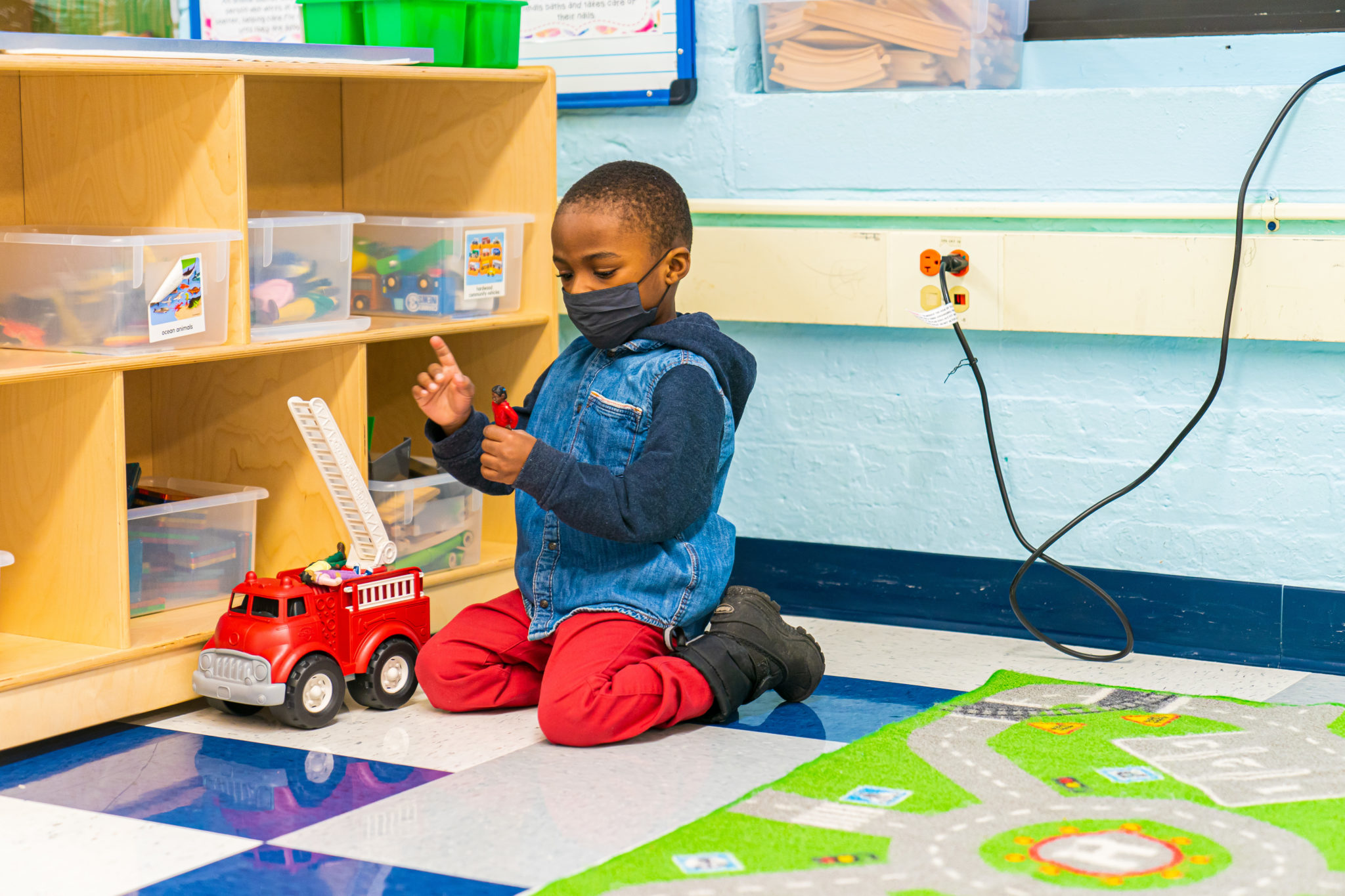 A boy playing with a truck