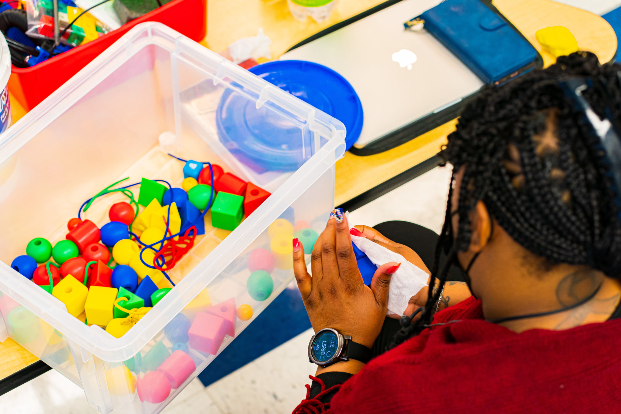 A teacher cleaning toys