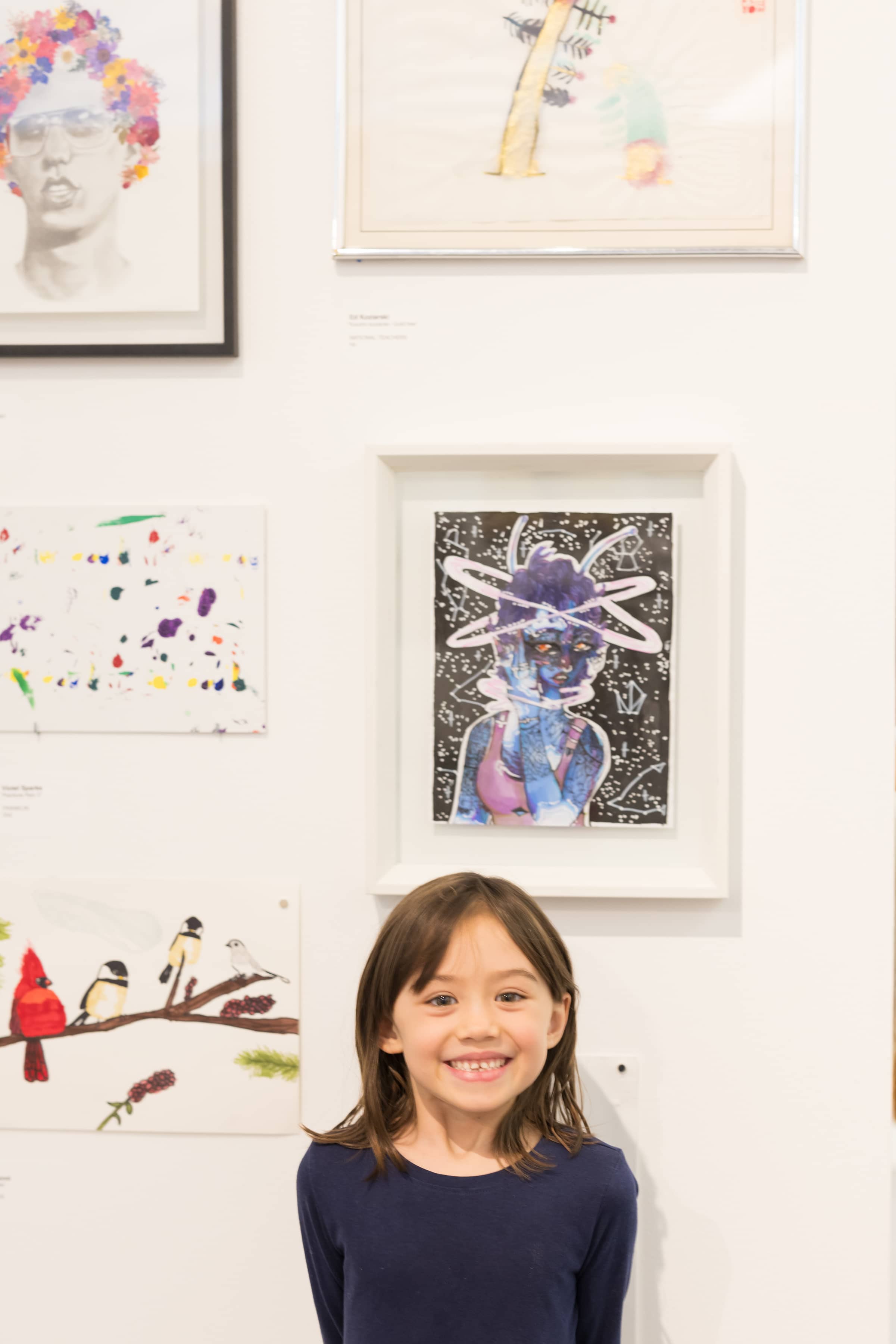 smiling student with artwork